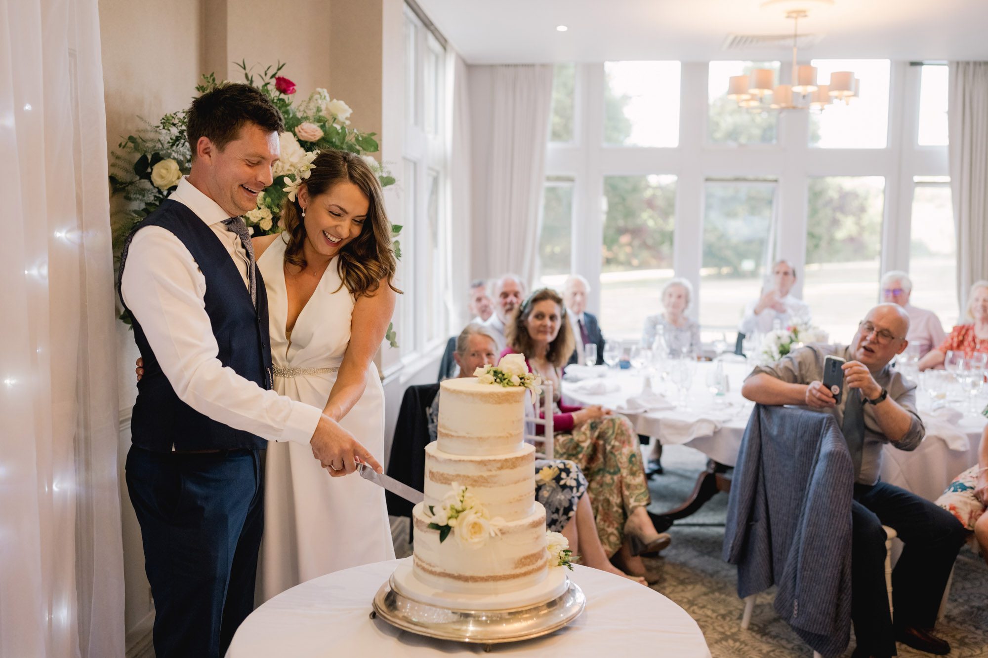 Bride and groom cut their wedding cake at Hartsfield Manor.