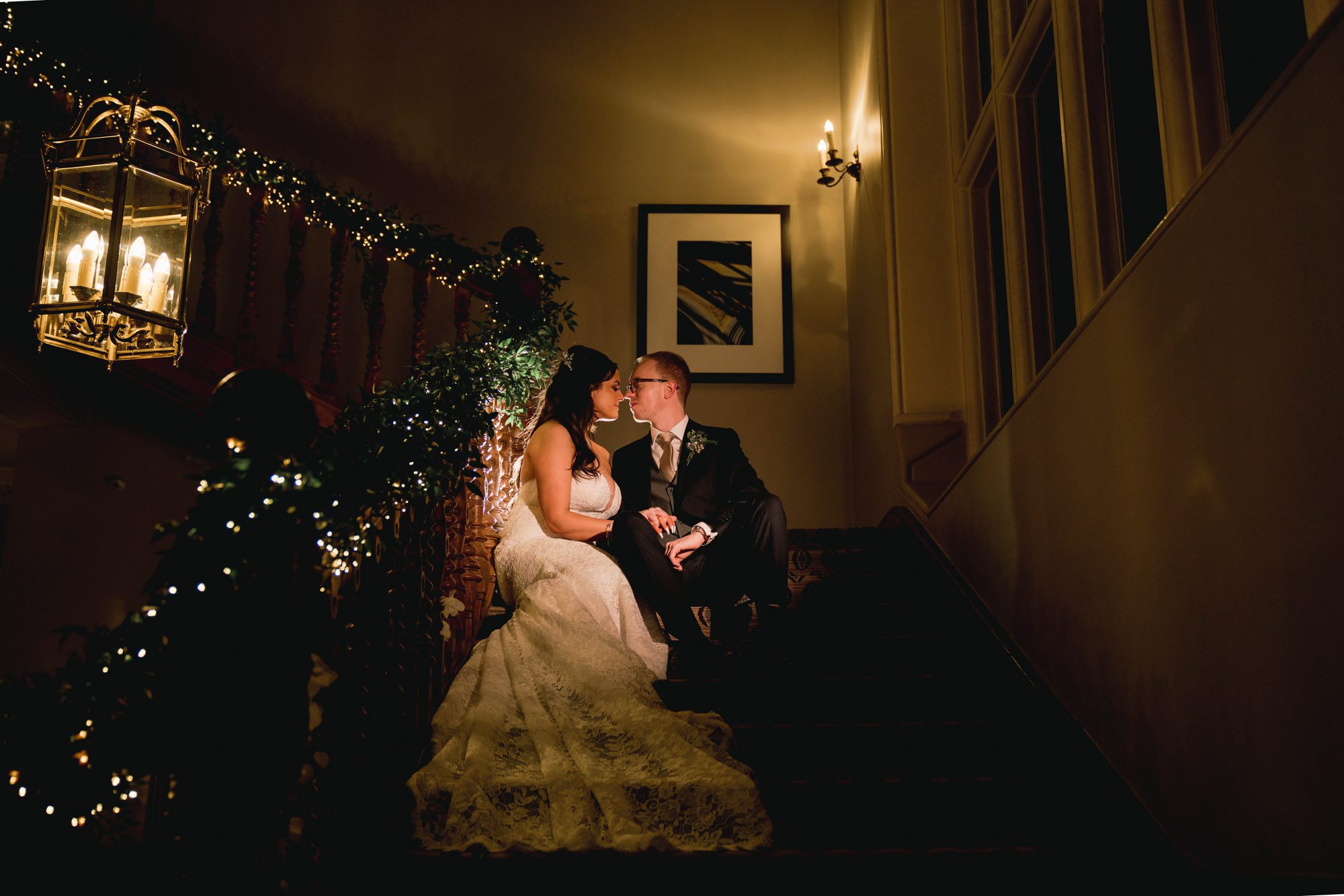 Bride and groom stare lovingly in to each other's eyes on the grand staircase.