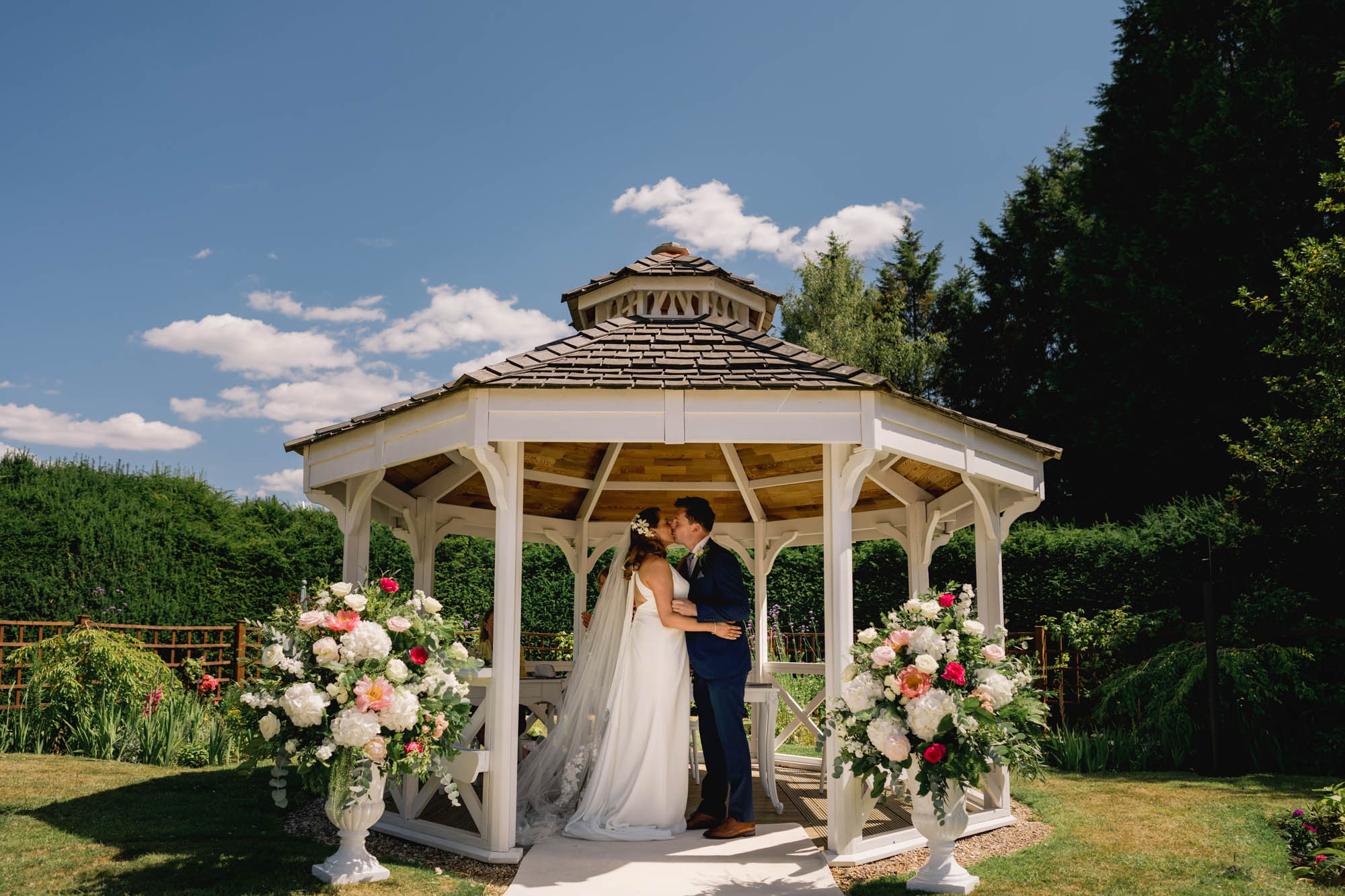 Bride and groom kiss on their wedding day at Hartsfield Manor.