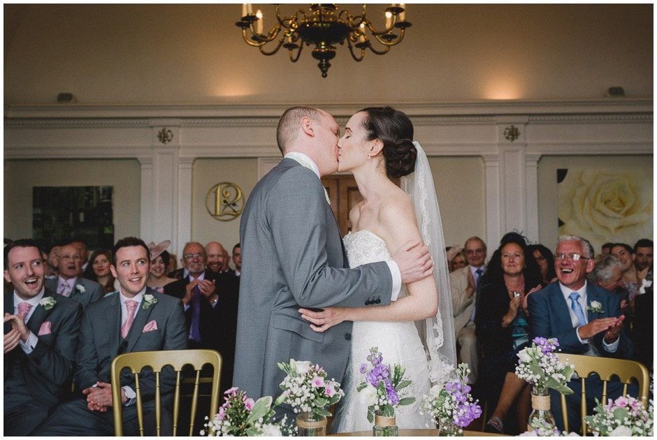 Bride and groom kiss at Greyfriars house wedding venue in Surrey.