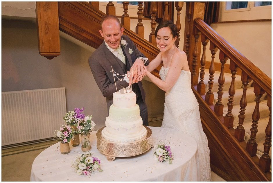 Bride and groom cut the cake at Greyfriars House in Surrey.