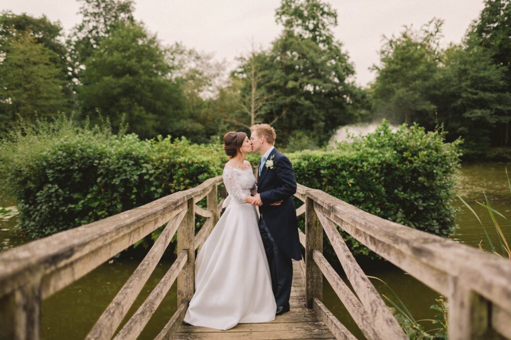 Bride and groom kiss on their wedding day at Ashdown Park.