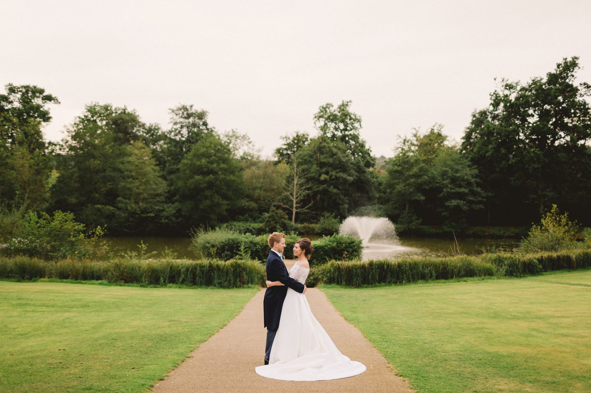 Bride and groom hug closely on their wedding day at Ashdown Park Wedding Venue in Sussex.