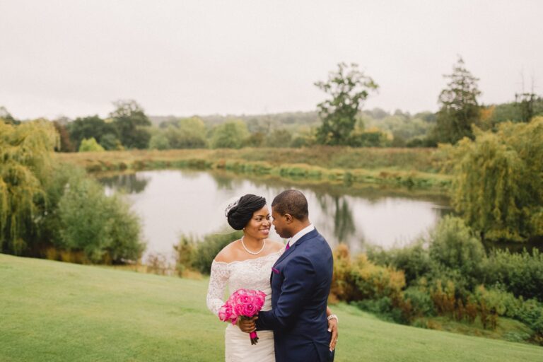 Bride and groom hug closely on their wedding day at Northbrook Park.