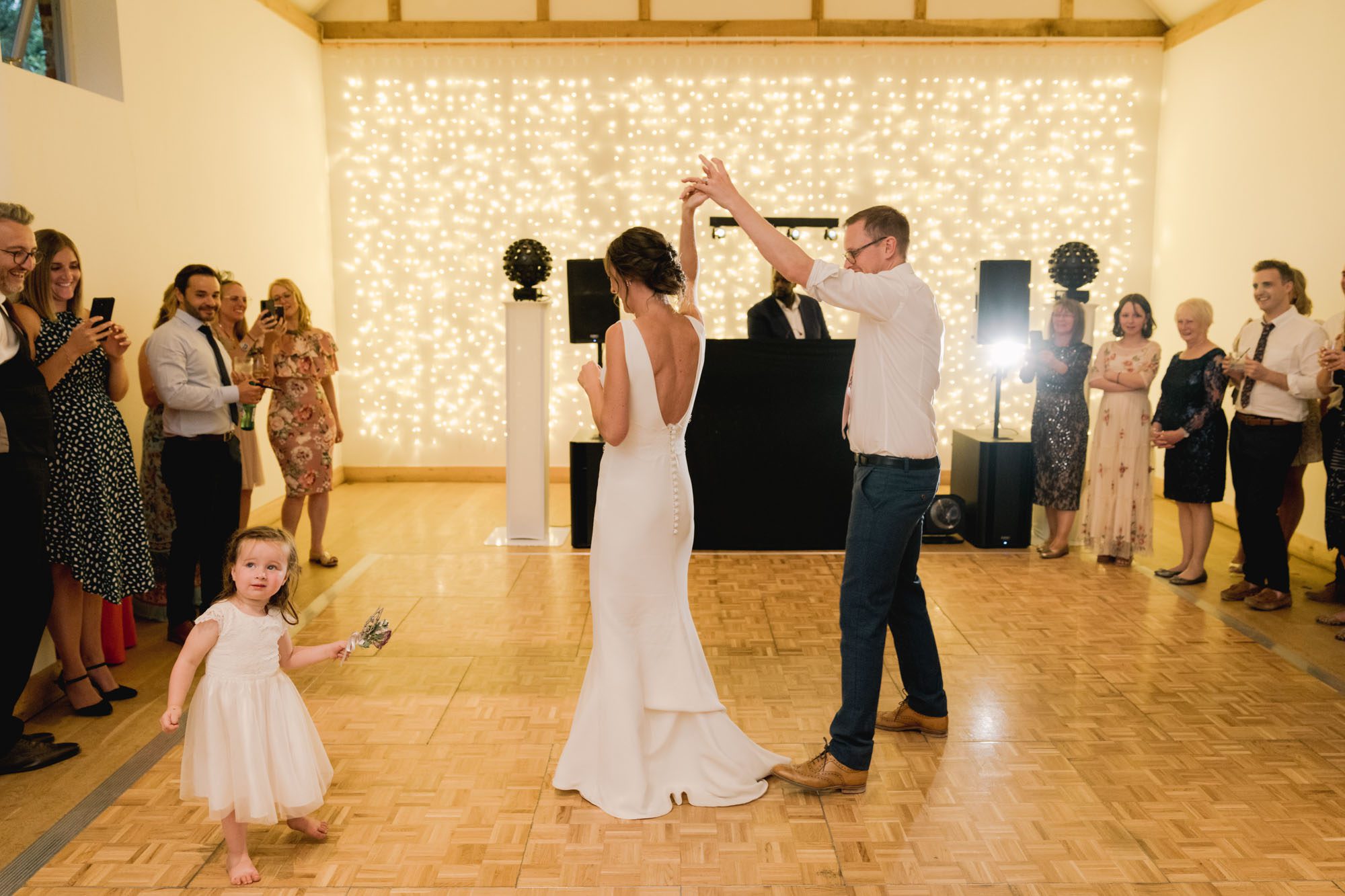 A bride and groom have their first dance on the dancefloor as their guests watch at Dorney Court in Buckinghamshire.