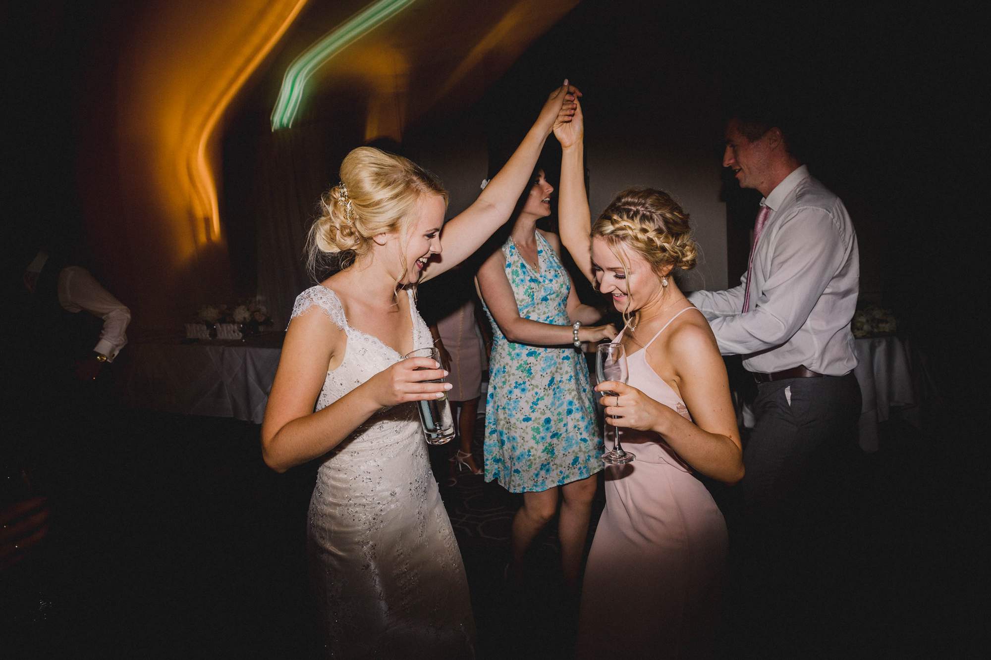 Bride dances with her bridesmaid at Wotton House.