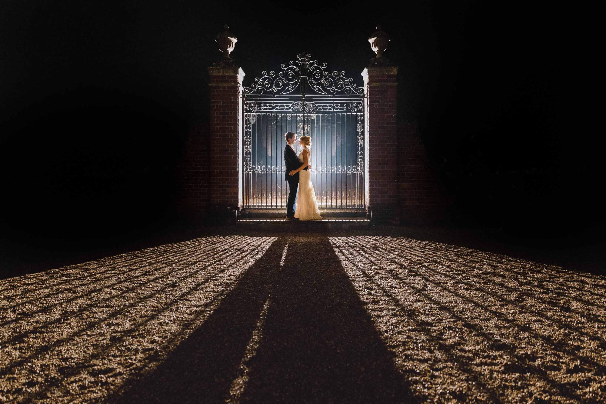 Bride and groom pull each other close in the evening at Wotton House in Dorking.