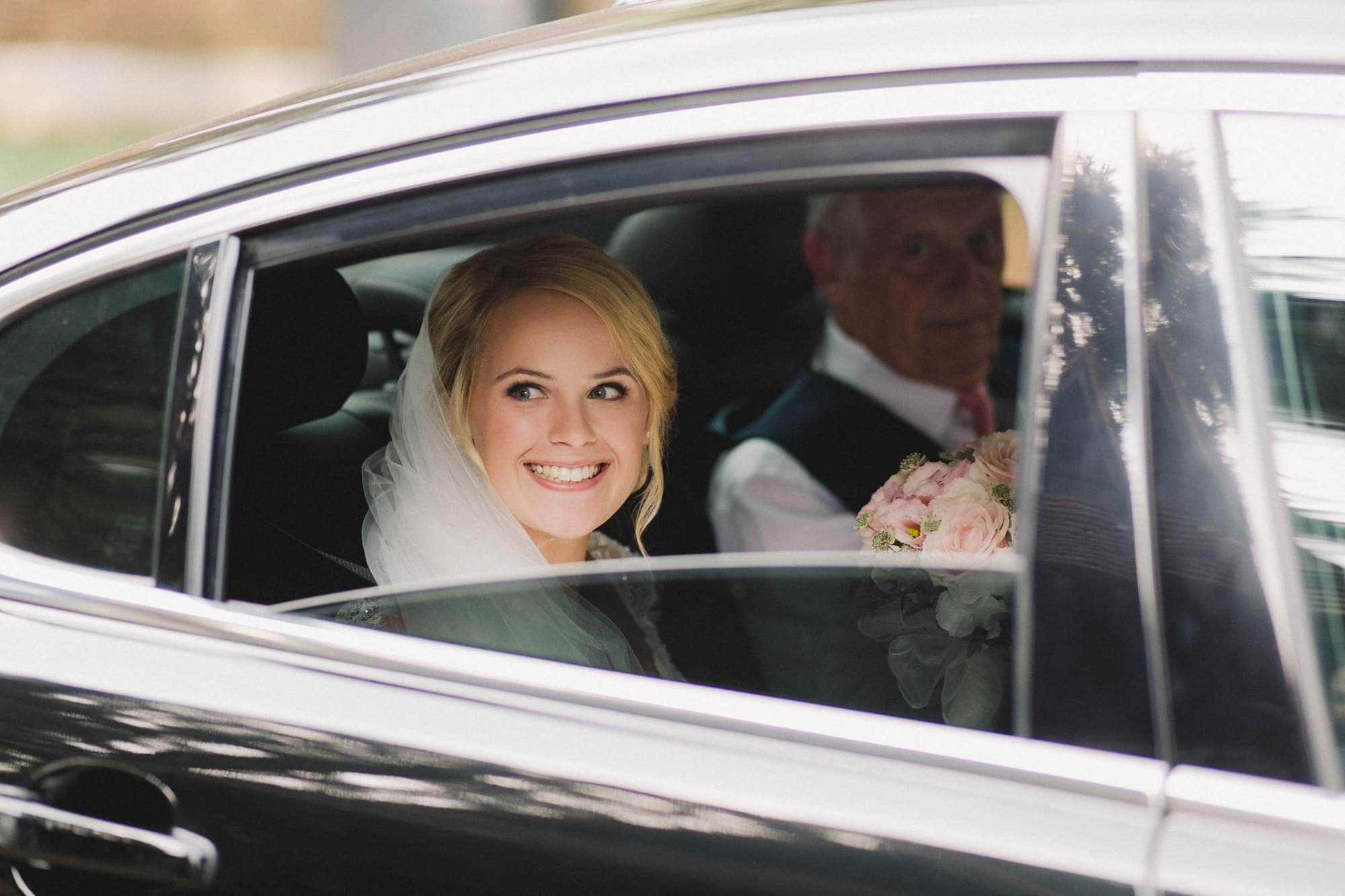Bride arrives in a car for the ceremony at Wotton House.