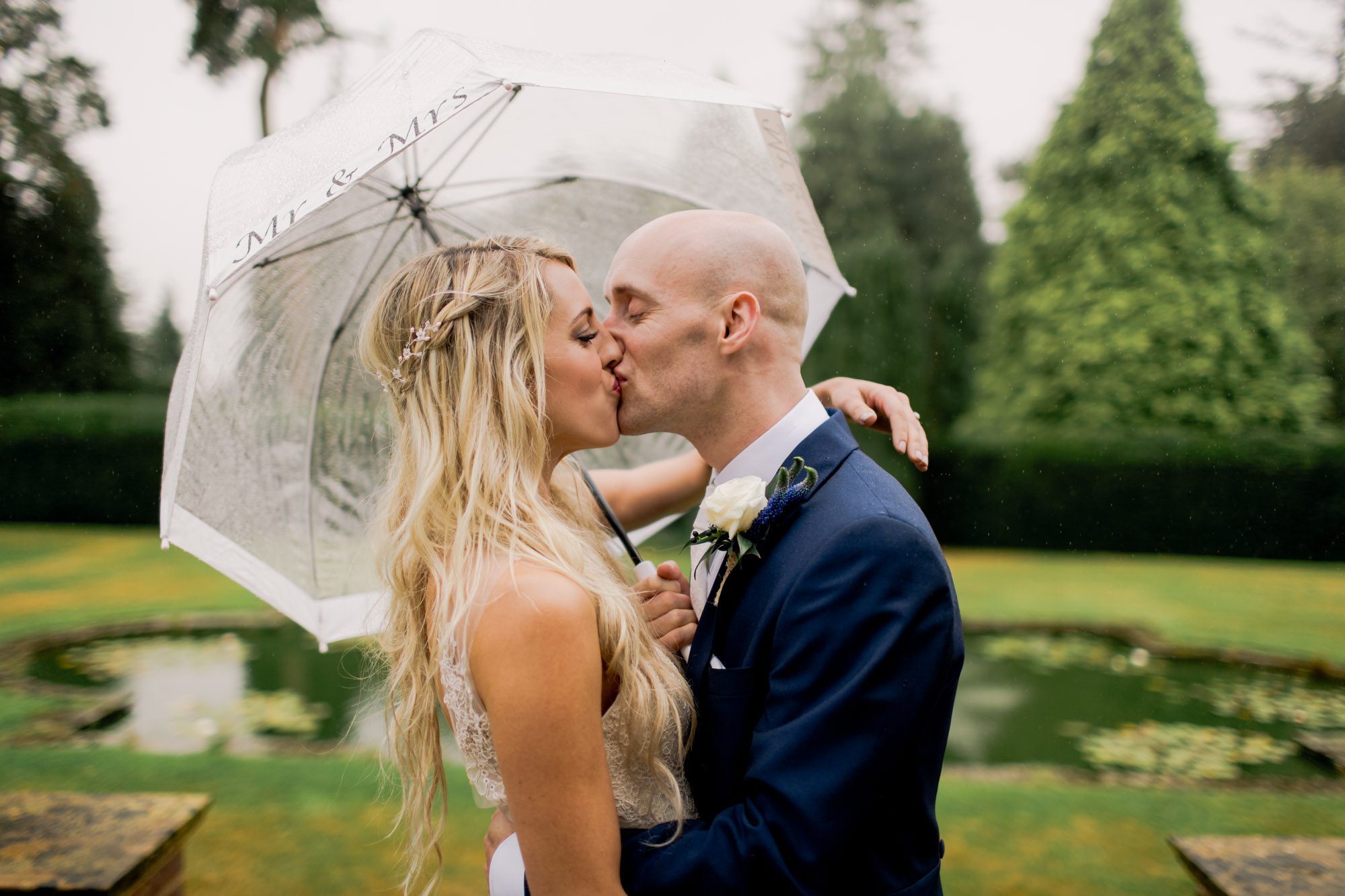 Bride and groom kiss on their wedding day at Barnett Hill in Surrey.