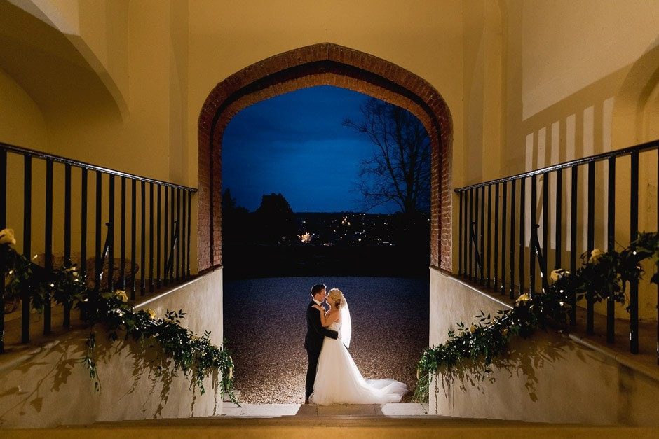 A couple enjoying the night sky at Farnham castle on their wedding day.