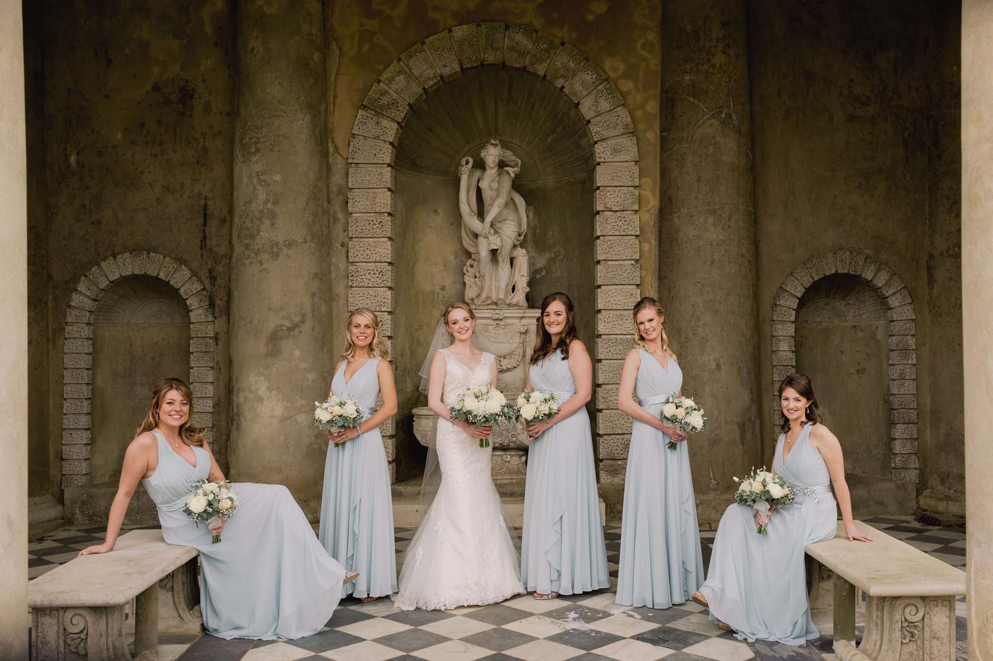 Bride and her bridesmaids pose for a group shot at Wotton House.