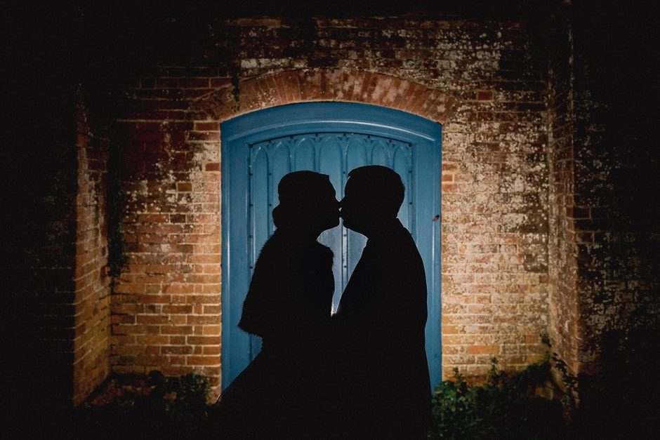 Silhoutted bride and groom at farnham castle wedding venue.
