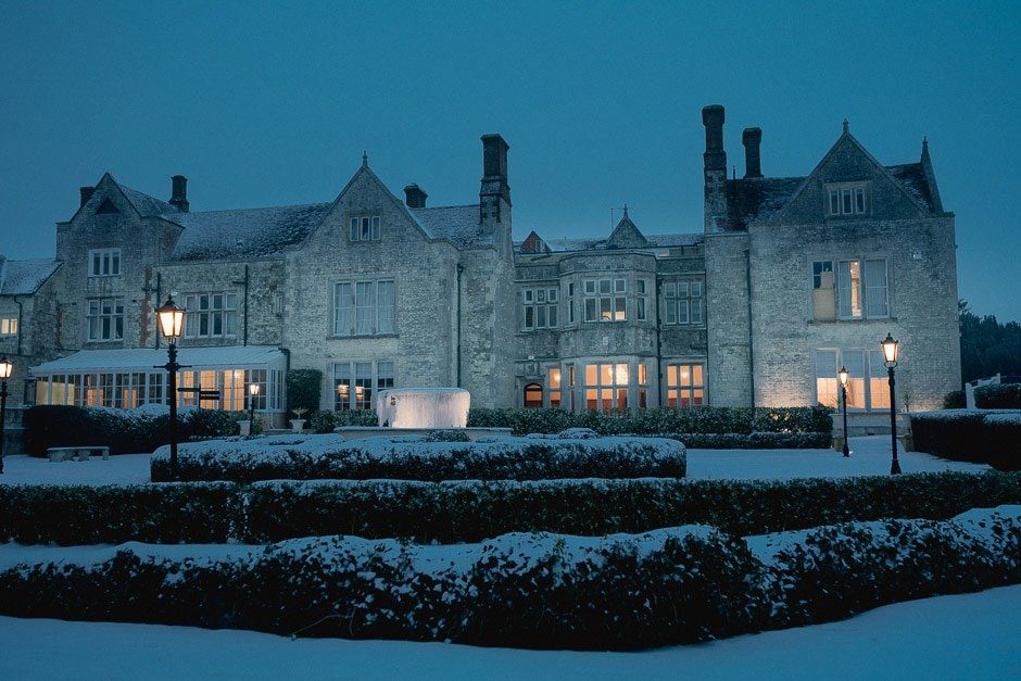 Froyle Park wedding venue in the snow under a twilight sky in the evening.
