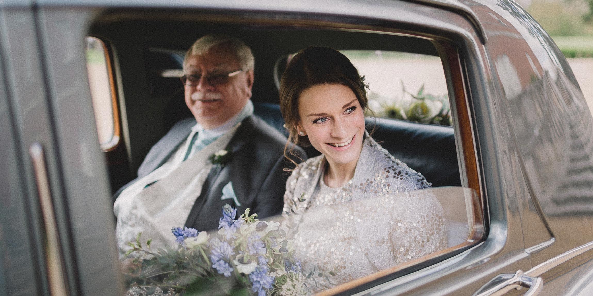 A bride arrives in the car at Clandon Park in Surrey.