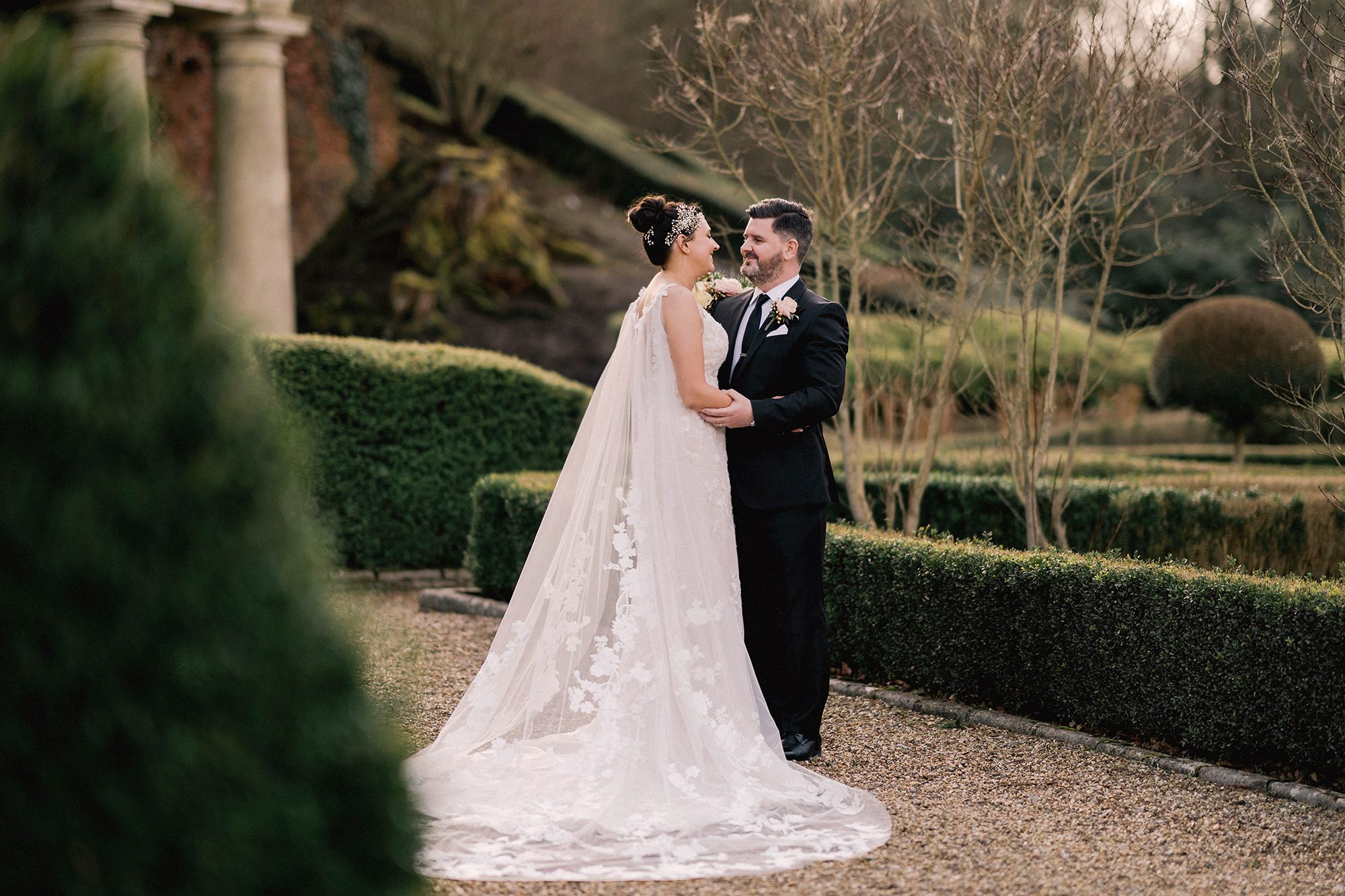 Bride and groom stare lovingly in to each other's eyes on their wedding day at Wotton House in the Surrey Hills.