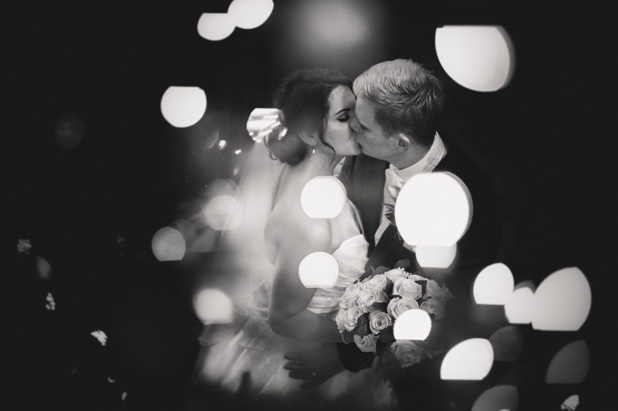 Bride and groom kiss on amongst a sea of fairylights at Wotton House Hotel.