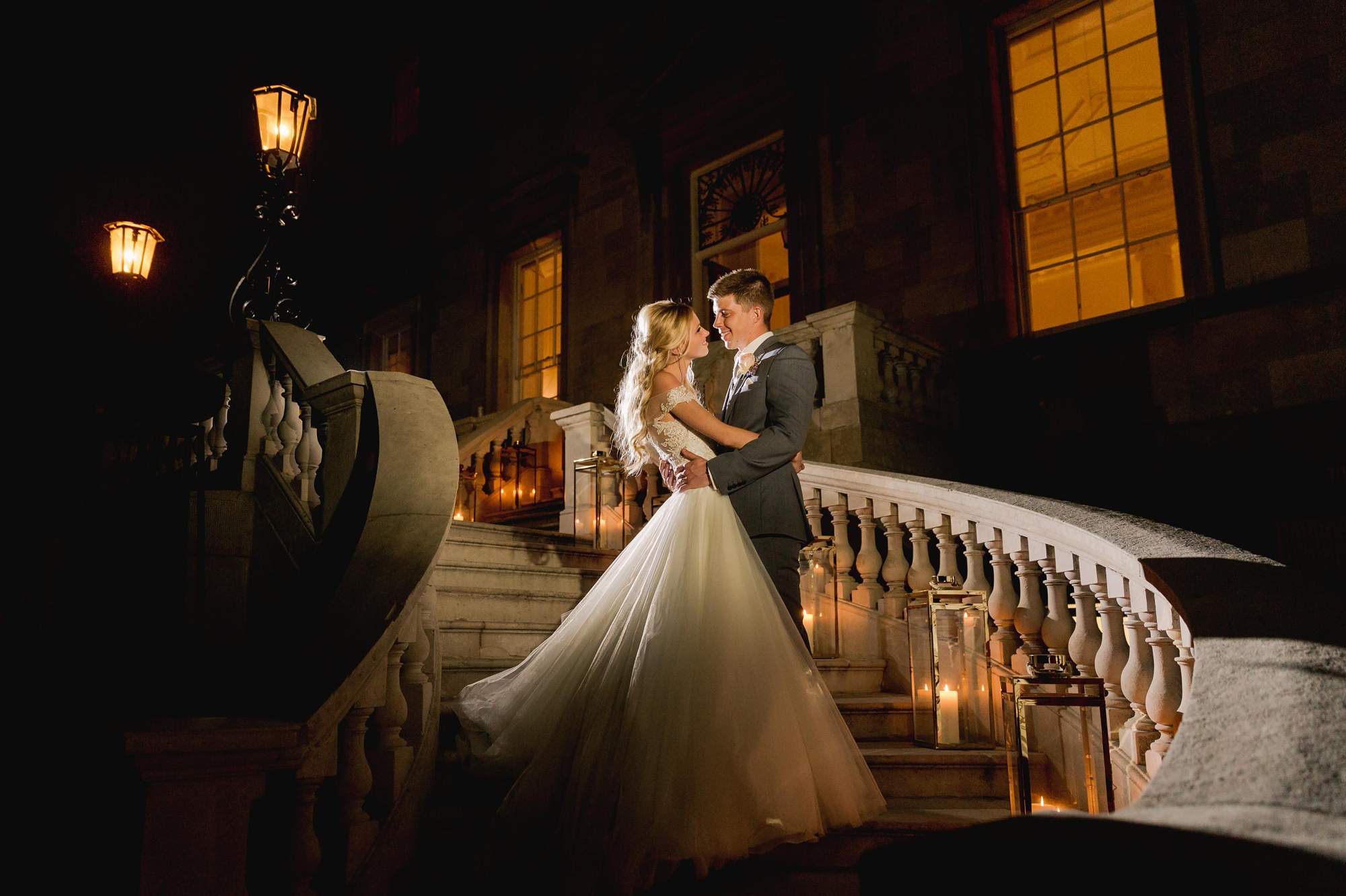 Bride and groom stare lovingly in to each other's eyes in the evening at Botleys Mansion.