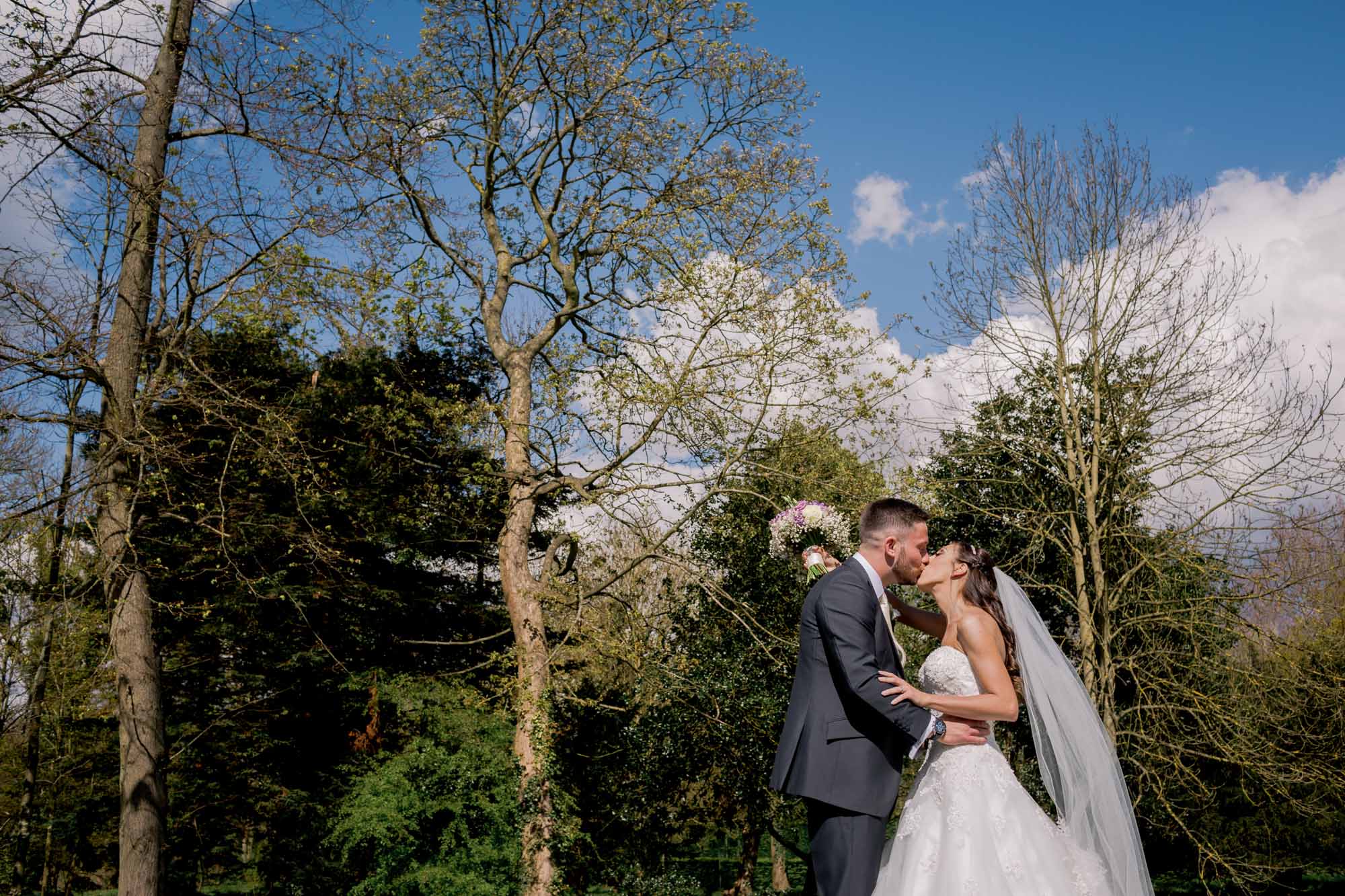 Bride and groom kiss on their wedding day at Great Fosters.