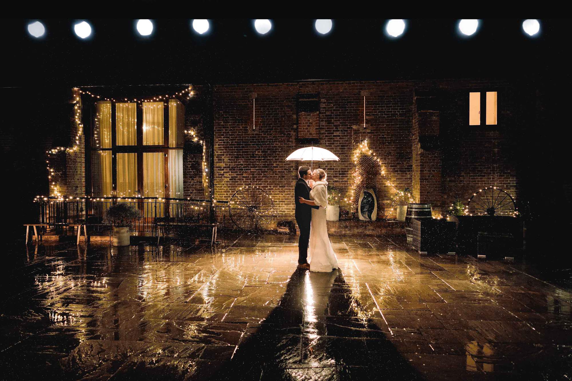 Bride and Groom in the rain at Long Furlong Barn in Sussex