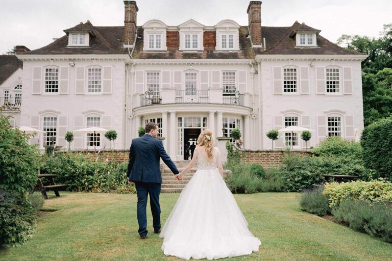 Bride and room walking on their wedding day at Gorse Hill in Surrey