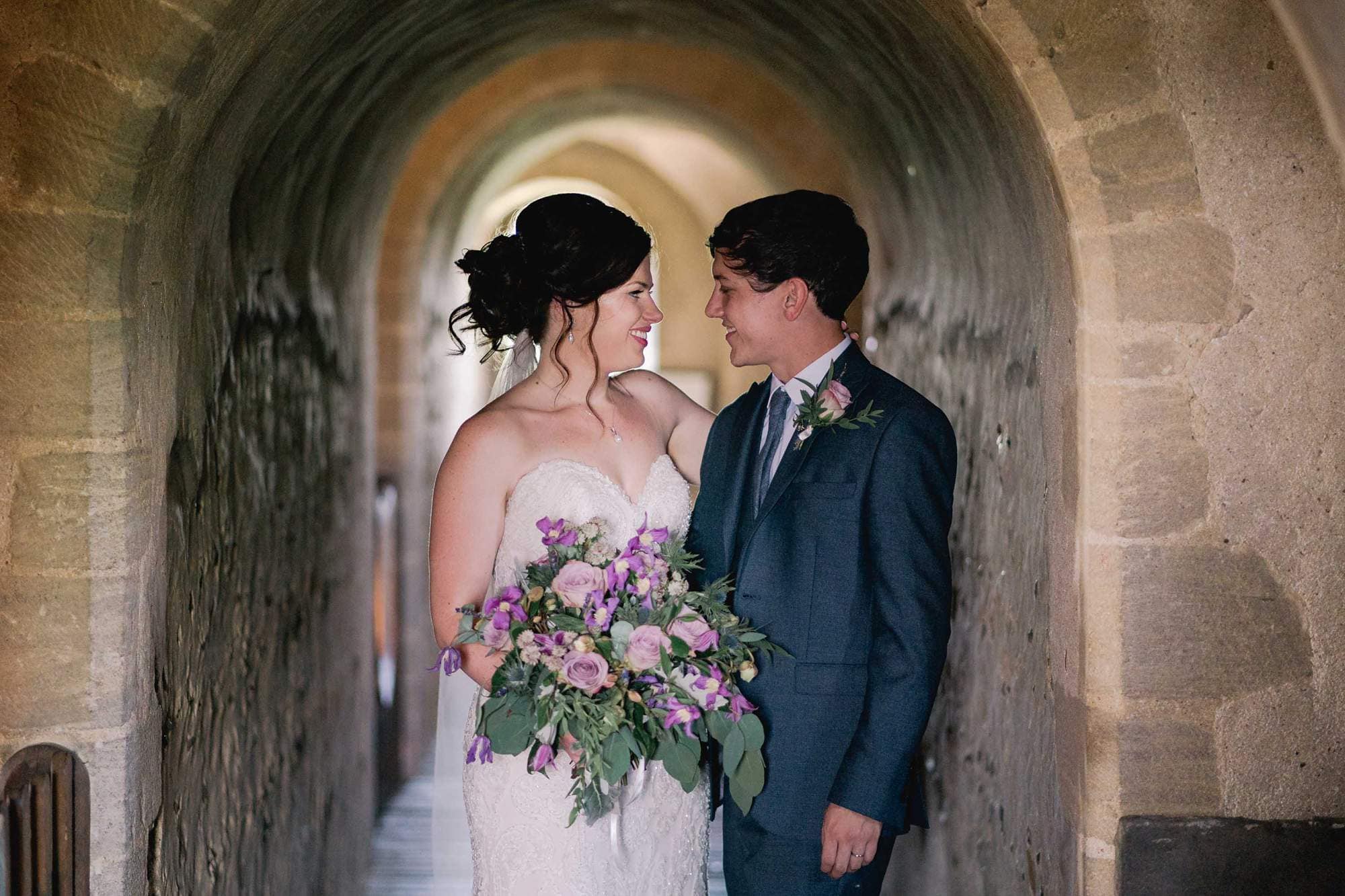 Bride and groom stare lovingly in to each other's eyes on their wedding day at Hedingham Castle in Essex.