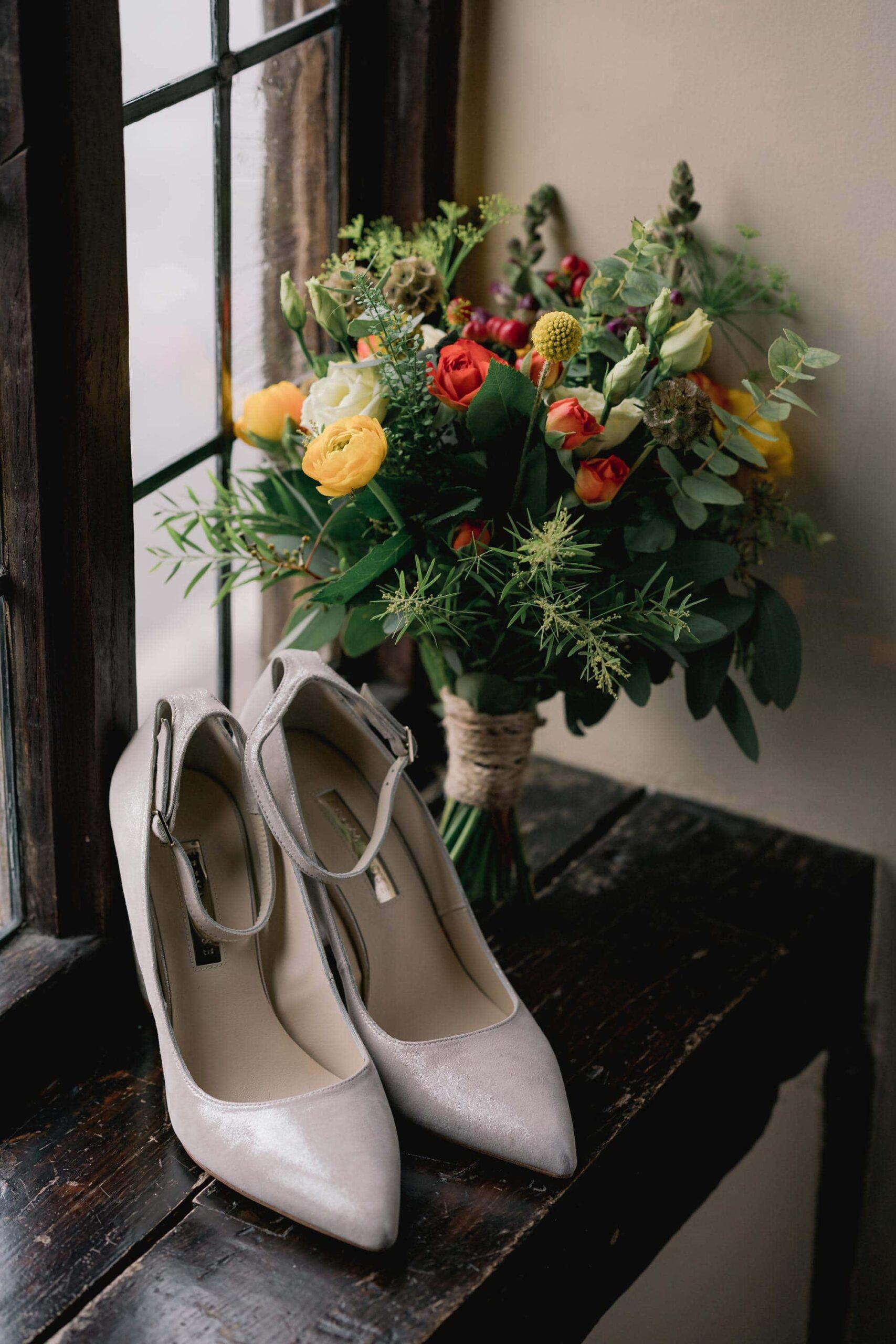 Wedding shoes and flowers at Ramster Hall.