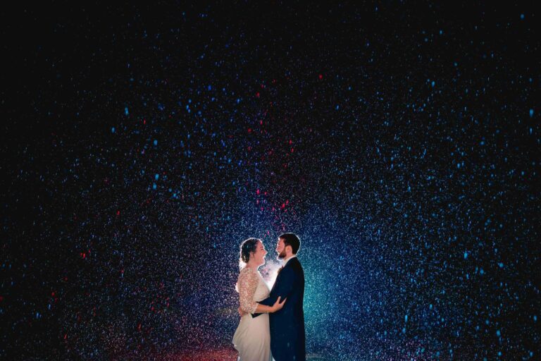 Bride and Groom in the rain at Hartsfield Manor in Surrey