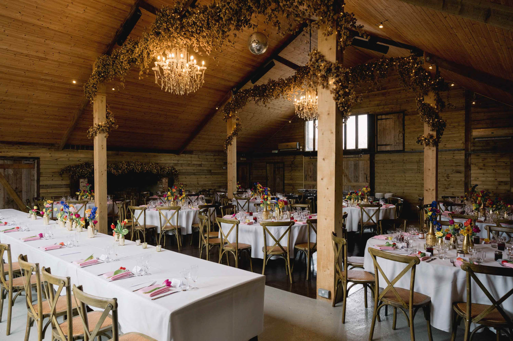 Interior of High Billinghurst Farm showing the wedding breakfast tables.
