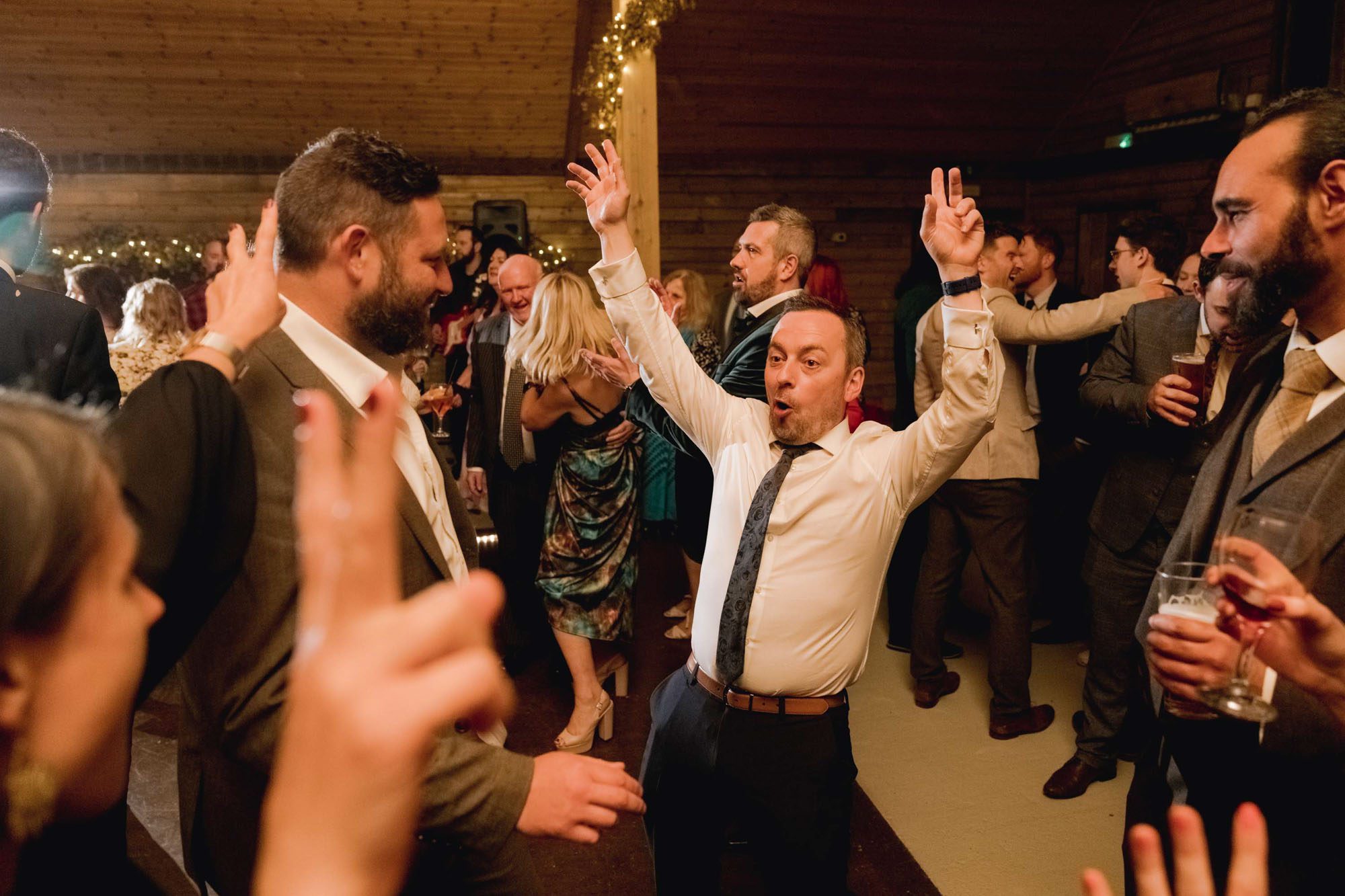 A guest dancing on the dance floor at a wedding.