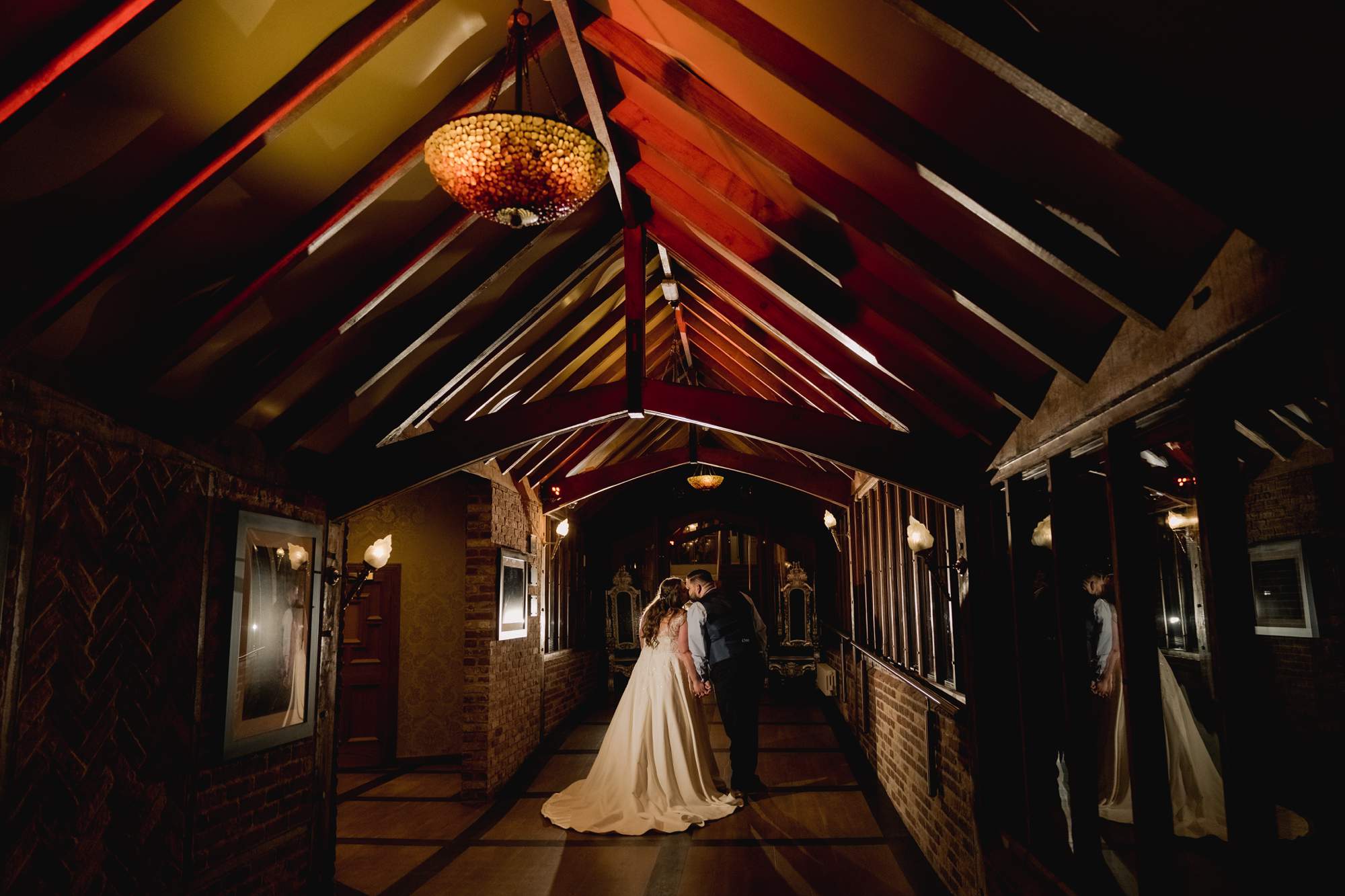 Creative moment with the bride and groom at they take a stroll through the corridors at night at Old Thorns.