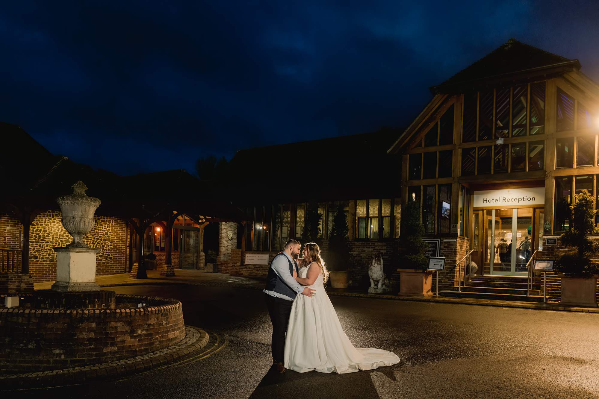 A couple under the twilight sky on their wedding day at Old Thorns Hotel in Hampshire.