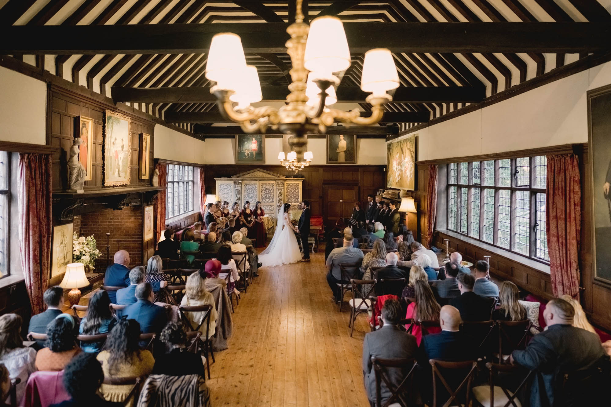 Bride and groom have their wedding ceremony at Ramster Hall in the Great Drawing Room.