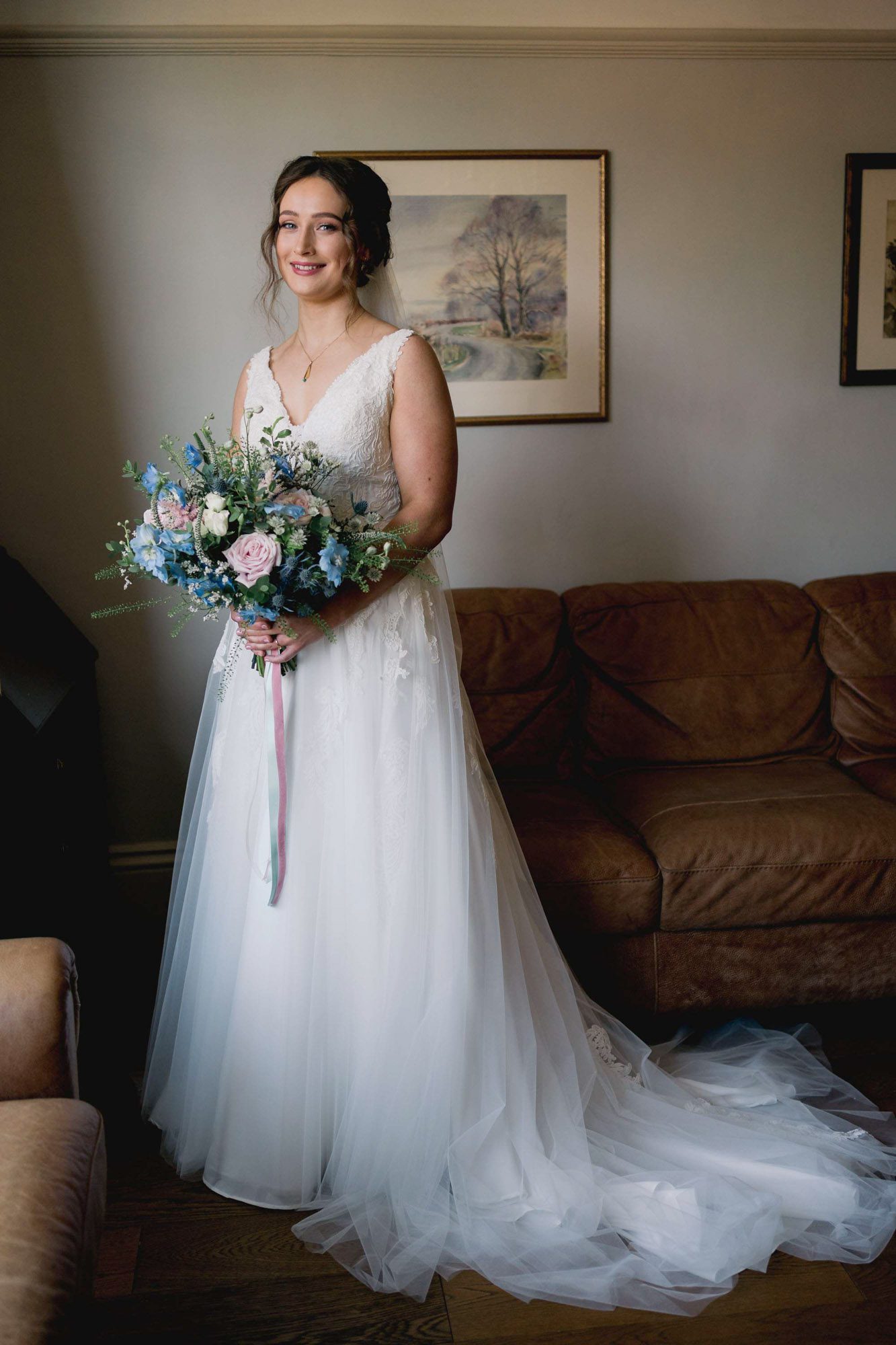 A bride in a beautiful wedding dress holding her bouquet of flowers ready for her wedding at Salomons Estate in Tunbridge Wells.
