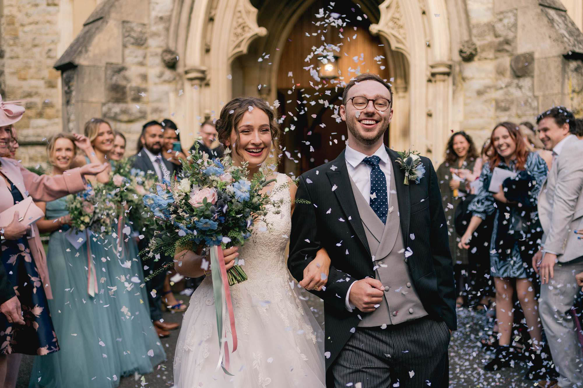Wedding guests throw confetti at the bride and groom on their wedding day at Salomons Estate in Tunbridge Wells.