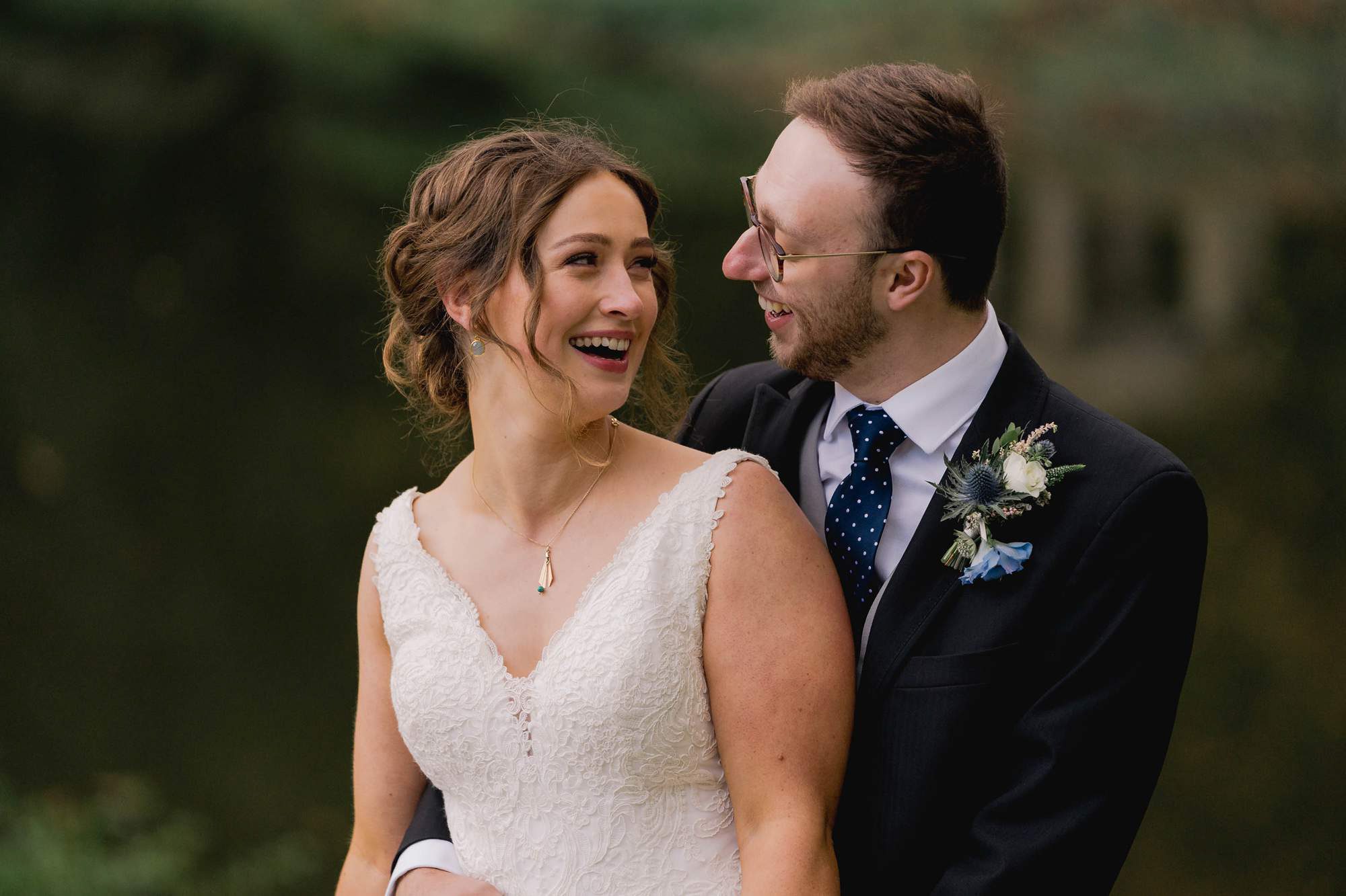 Bride and groom laugh together on their wedding day at Salomons Estate in Tunbridge Wells.