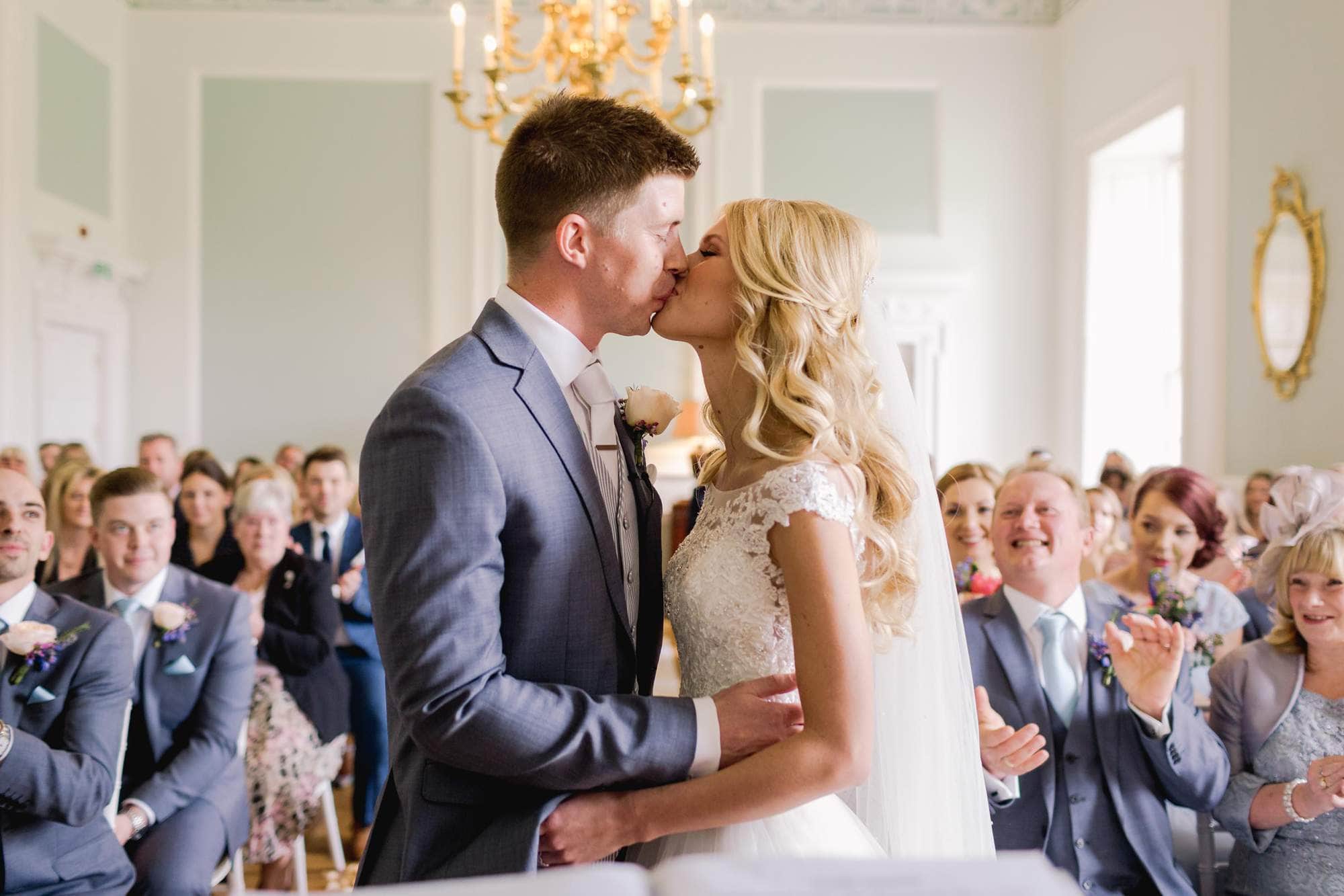 Bride and groom kiss on their wedding day at Botleys Mansion in Surrey.