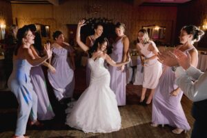 A bride and her bridesmaids on the dancefloor at a wedding in Winchester.