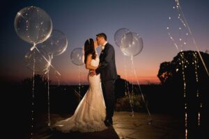 Winchester wedding with bride and groom and their balloons at sunset.