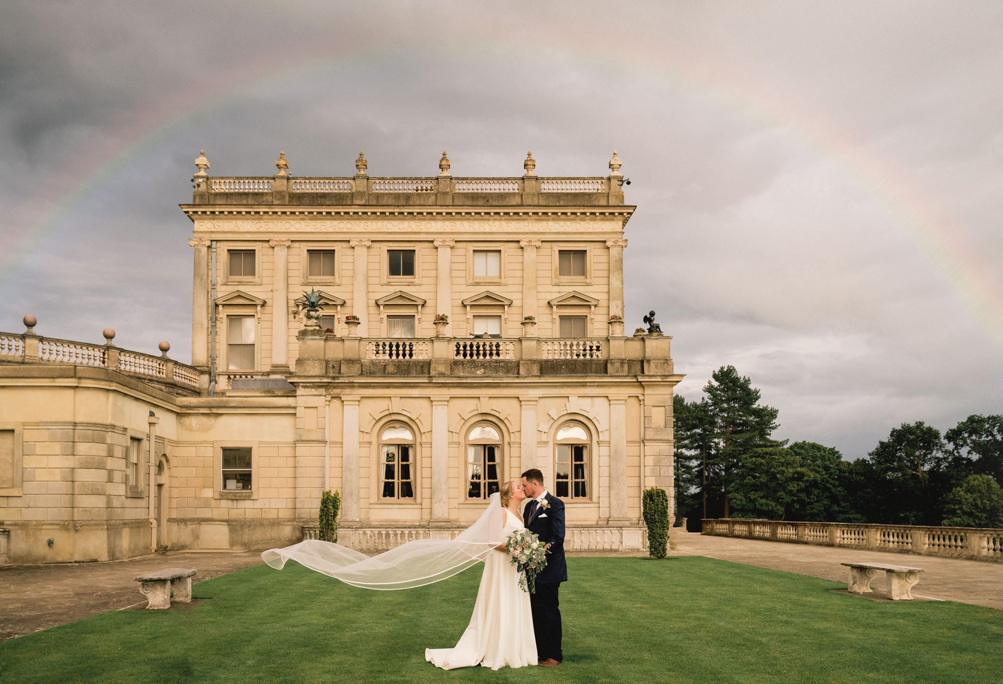 Bride and groom hug closely on their wedding day at Cliveden House.