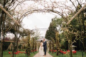 Guildford manor wedding photographer capturing the bride and groom in the gardens
