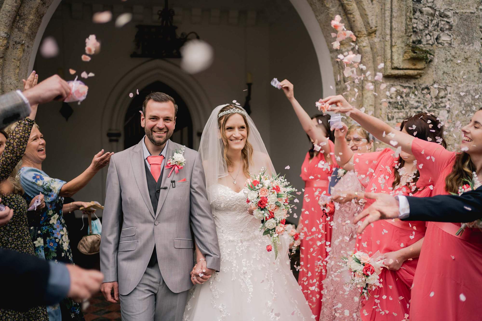 Bride and groom have confetti thrown at them at wedding at Castle Goring.
