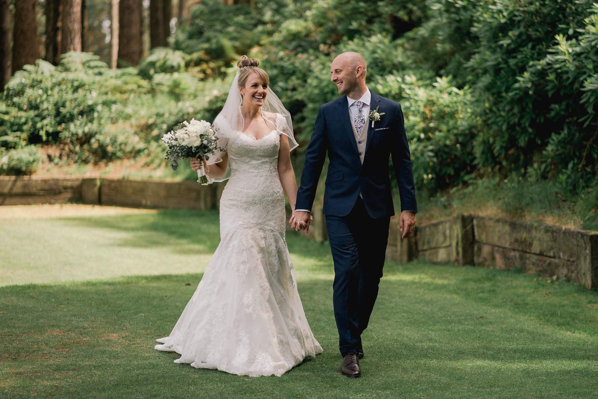 Bride and Groom walking together on the golf course at Old Thorns Hotel and Spa in Liphook. 