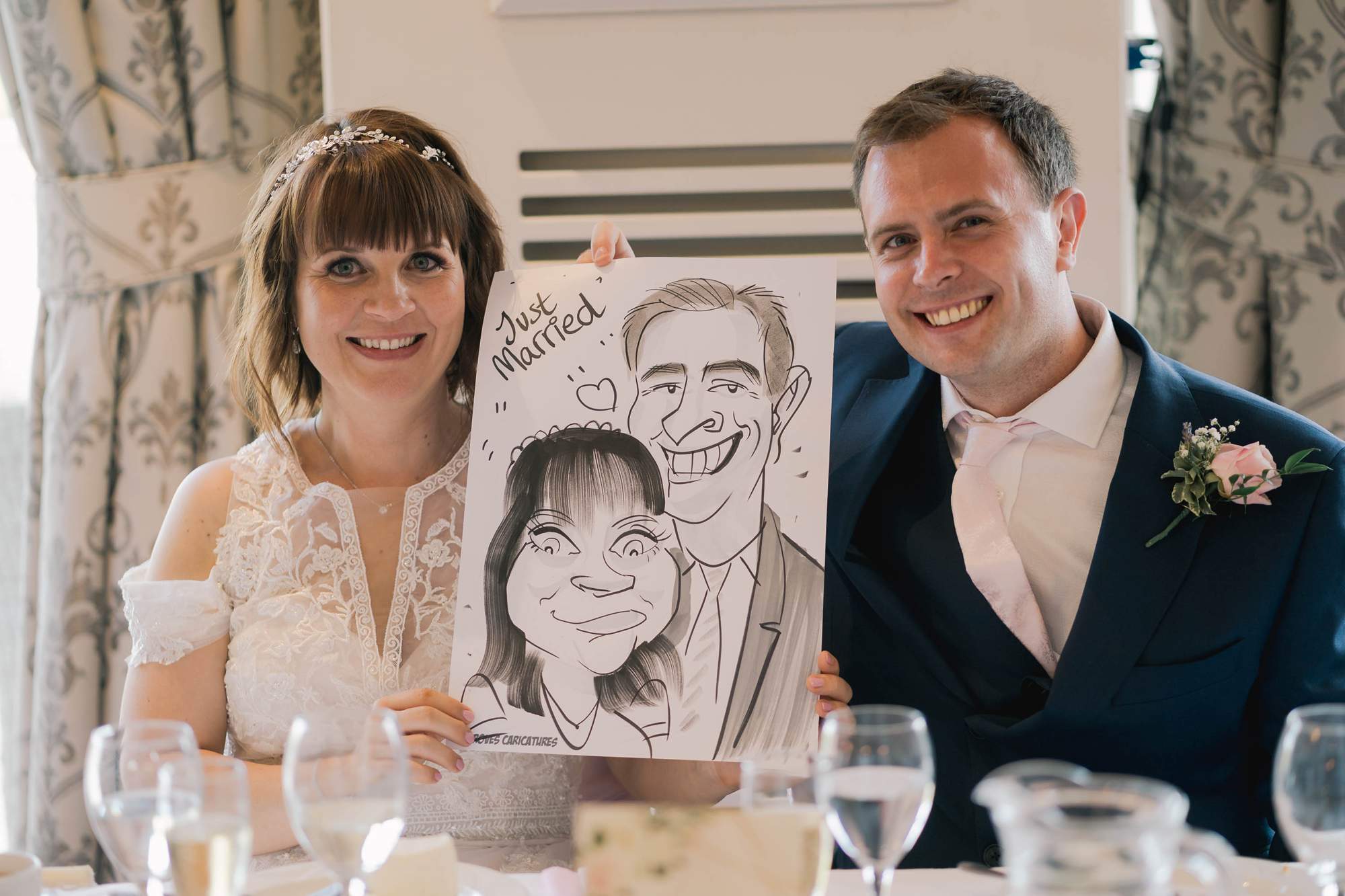 Newlyweds with a cartoon picture in their hands at the Hydro hotel.
