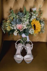 Shoes and flowers at a wedding at Gildings Barn in Surrey.