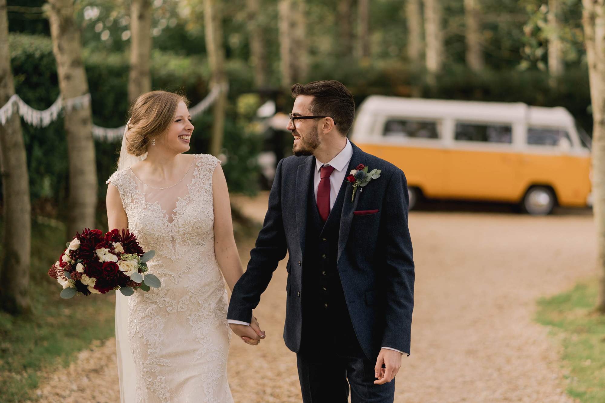 Bride and groom take a walk on their wedding day at Rumbolds Farms wedding venue in Billingshurst, Sussex.