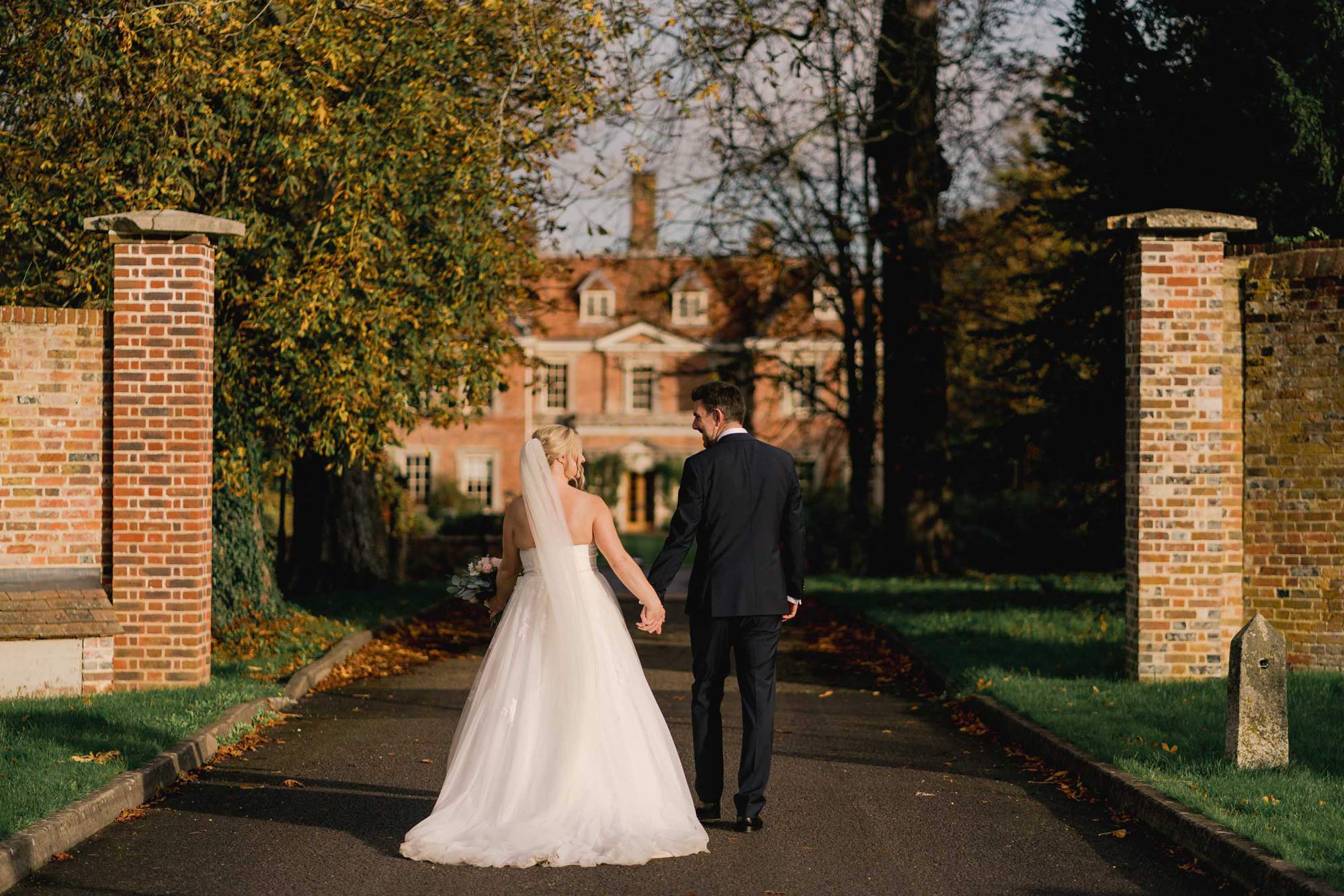 Bride and Groom walking together, holding hands at Lainston House in Winchester.