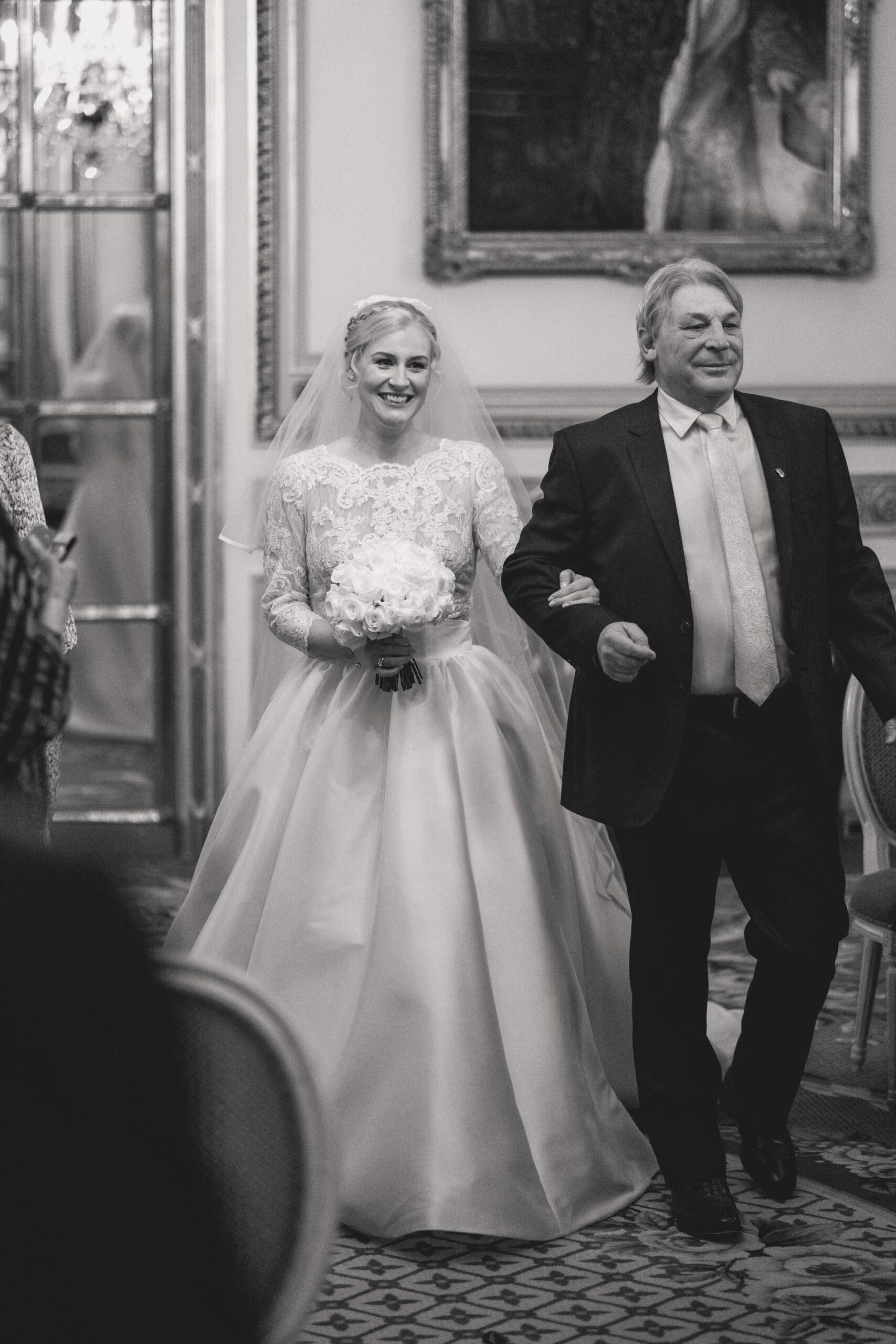 Bride walking down the aisle with her father at the Ritz hotel in London.
