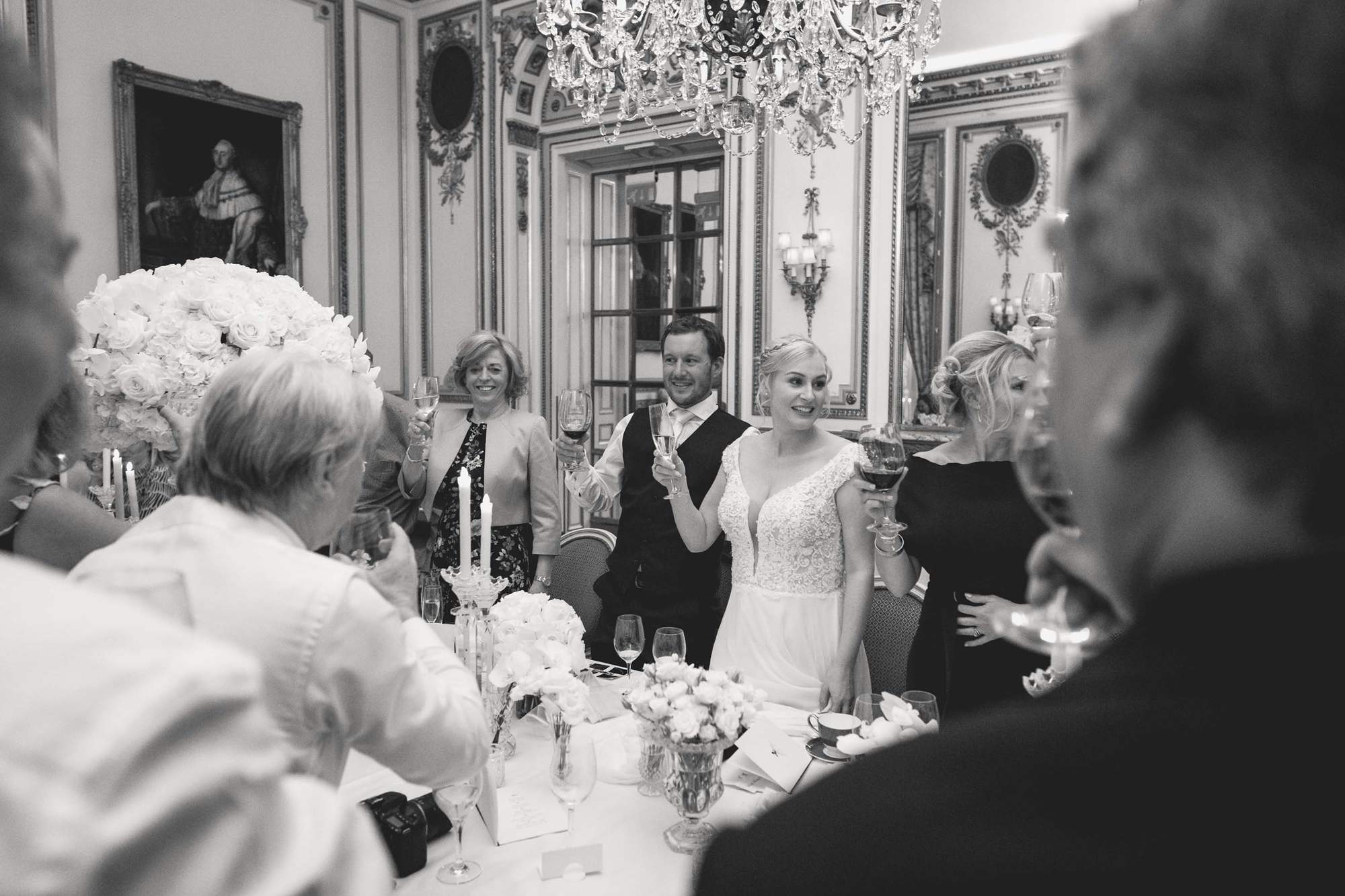 Bride and groom toast the speeches at the Ritz Hotel in London.
