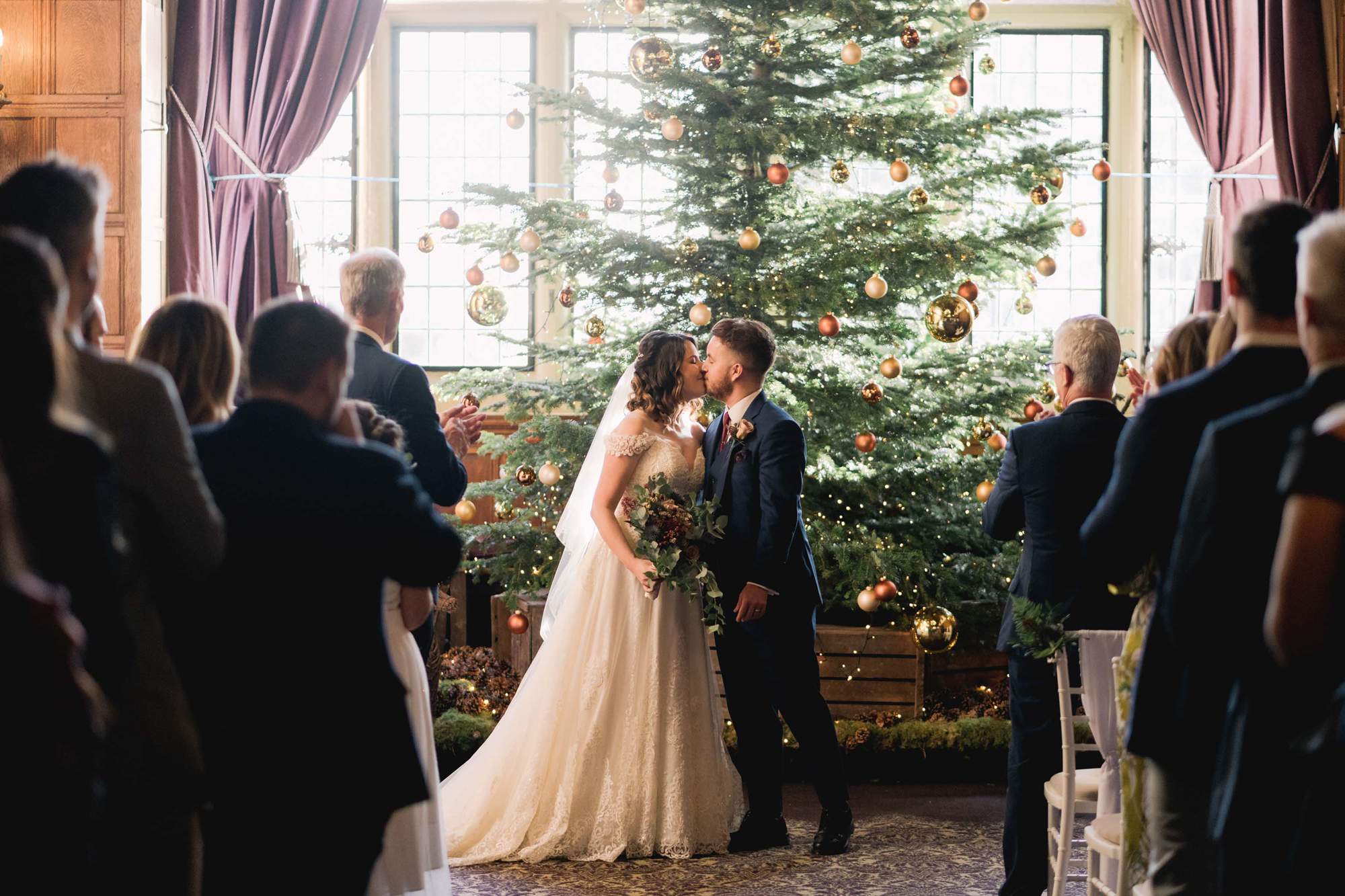 Bride and groom have their first kiss at Rhinefield House wedding venue in Hampshire.