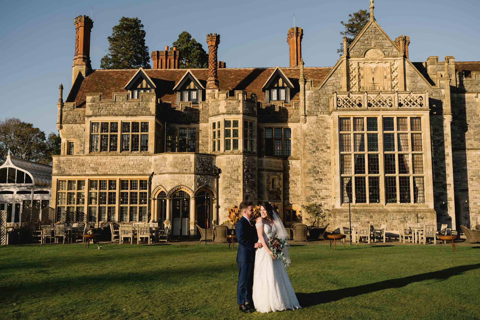 Bride and groom have a cuddle at Rhinefield House wedding venue in Hampshire.